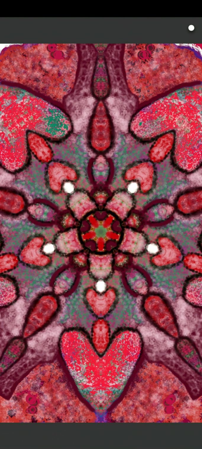 Red and pink intricate mandala design featuring hearts and floral patterns.